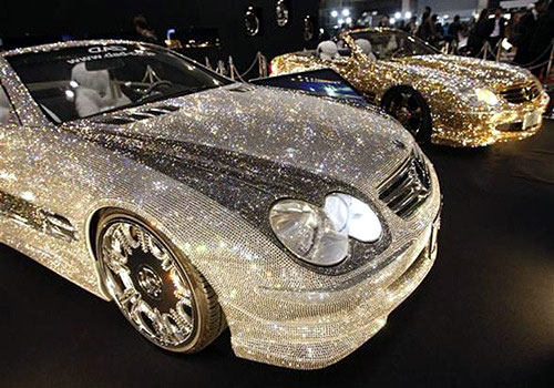 Customized Mercedes-Benz SL600s, Luxury Crystal Benz, studded with 300,000 Swarovski crystal glass, are displayed at the pavilion of custom car accessory company Garson/D.A.D at Tokyo Auto Salon 2010.