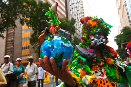 A demonstrator wears a costume that represents the Amazon rainforest during a march at the People's Summit at Rio+20 for Social and Environmental Justice in Rio de Janeiro.
