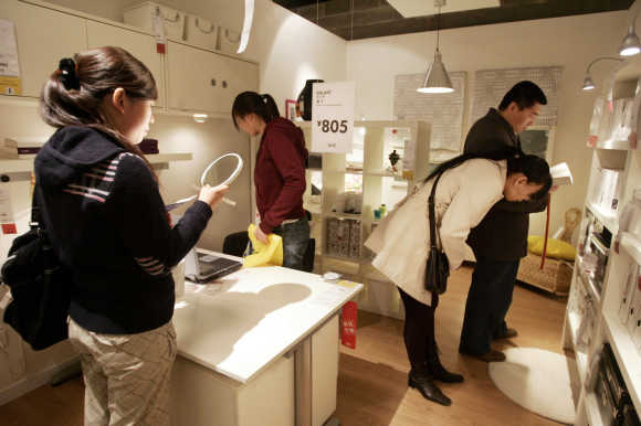 Chinese customers look at products on display at the Ikea store in Beijing.