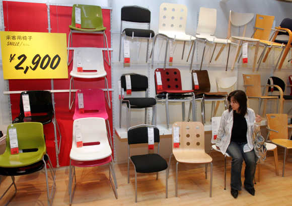 A Japanese woman takes a seat on one of Ikea's chairs at the company's store in Japan in Funabashi, east of Tokyo.