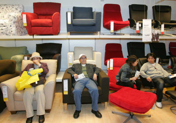 Japanese shoppers sit on Ikea's sofas at a store in Funabashi, east of Tokyo.