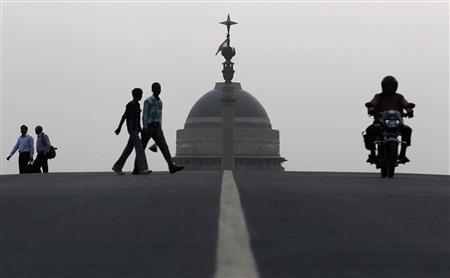 People walk in front of India's presidential palace Rashtrapati Bhavan