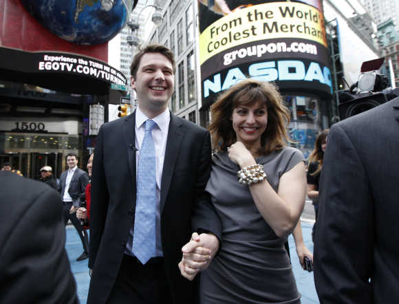 Groupon CEO Andrew Mason walks with his wife Jenny Gillespie outside the Nasdaq in New York.