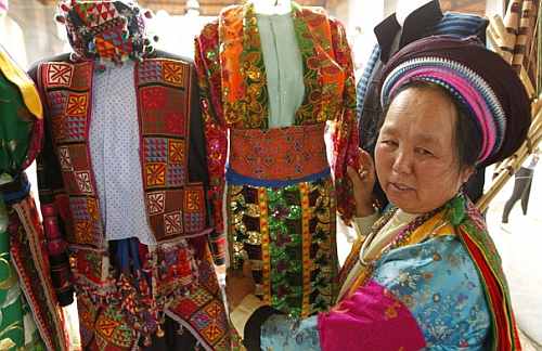 A Hmong woman displays traditional costumes for sale at the Vietnamese cultural village of Dong Mo, outside Hanoi