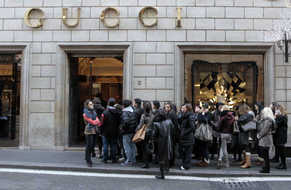 Shoppers wait for the opening of Gucci shop in downtown Rome.