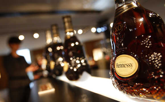 A customer looks at bottles of Hennessy X.O at the Hennessy factory in Cognac, southwestern France.