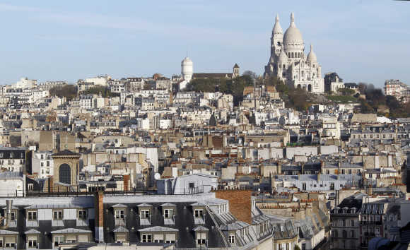 View of rooftops and the Montmartre's Sacre Coeur Basilica in Paris.