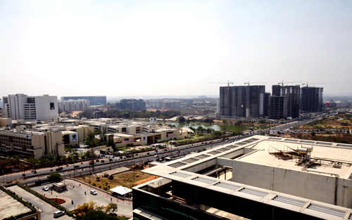 An elevated view shows a newly-built highway and the Gachibowli district in Hyderabad, which is home to many of Hyderabad's IT campuses.