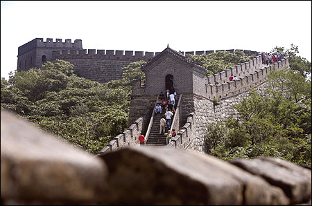 Tourists walk along the Mutianyu section of the Great Wall in Huairou District, Beijing.