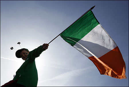 A boy holds a Republic of Ireland flag during a St Patrick's day march.