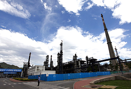 A security personnel stands guard at the Yanshan oil refinery of Sinopec Corp in Beijing.