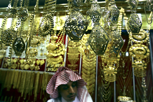 A salesman arranges gold necklaces at a jewellery shop in downtown Riyadh.