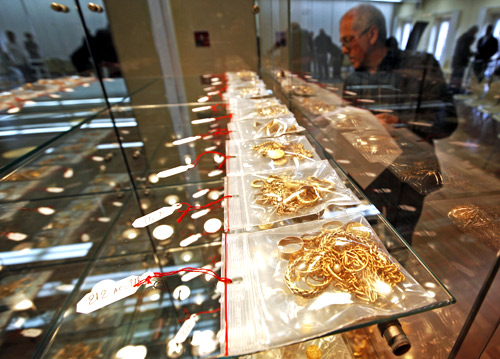 A man looks at jewels displayed for auction after being pawned by their owners at the Credit Municipal public pawnbroker in Nice.