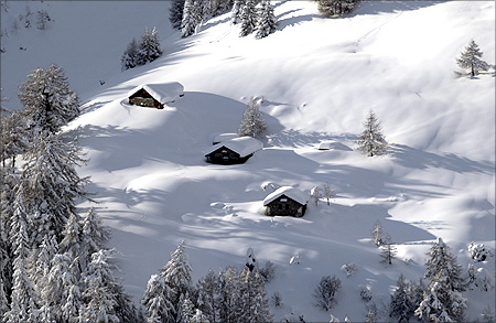Chalets are pictured after a snow fall on a winter day at the Vallee de la Sionne in Anzere near Sion.
