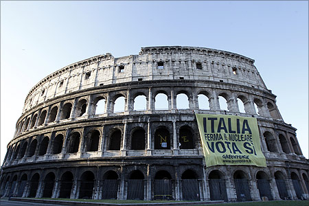 Members of environmental activist group Greenpeace unfurl a banner from Rome's ancient Colosseum.