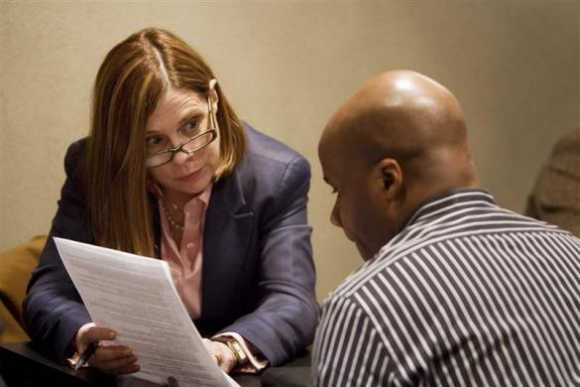 A job seeker listens to career coach Jane Cranston during a resume counselling session at a job fair in New York.