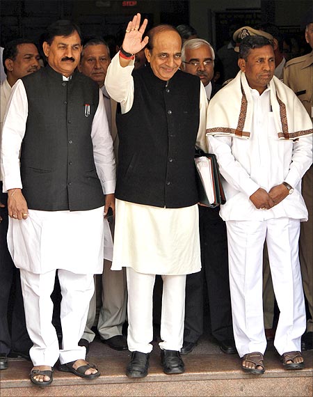 Railways Minister Dinesh Trivedi (C) waves as he leaves his office to present the Railway Budget.