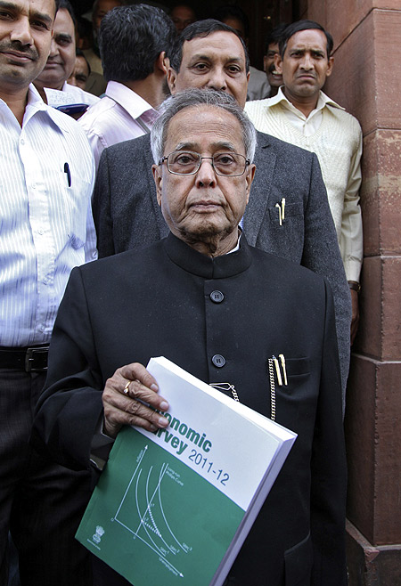 Finance Minister Pranab Mukherjee comes out of the parliament after presenting the 2011-2012 economic survey report in New Delhi.