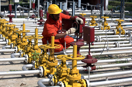An engineer of Oil and Natural Gas Corp (ONGC) works inside the Kalol oil field in Gujarat.