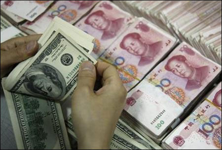 An employee counts US dollar banknotes at a branch of the Industrial and Commercial Bank of China in Huaibei.