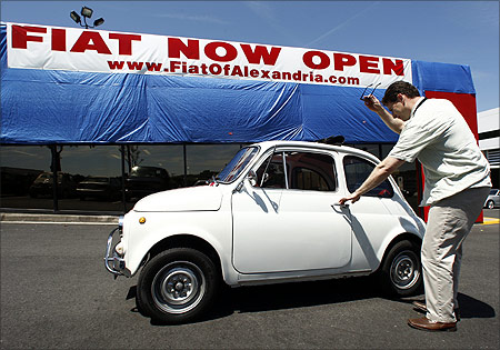 Mark Santaw of Woodbridge, Virginia, gets out from his 1971 Fiat 500 in front of a newly opened Fiat dealership in Alexandria, Virginia.