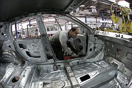 An employee works on an assembly line at a Fiat factory in the central Serbian town of Kragujevac.