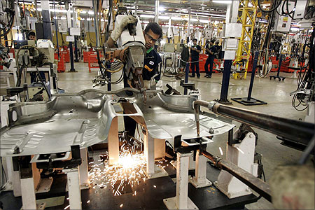Employees work in the Fiat factory at Ranjangaon.