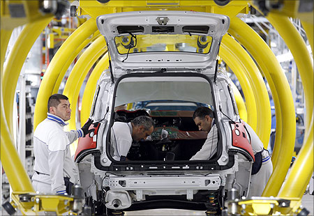 Employees of Fiat SpA work on new car
