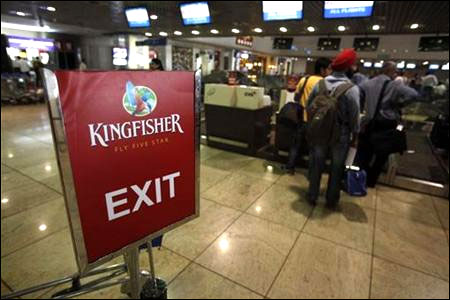 Kingfisher Airlines customers wait in a check-in queue at Mumbai's domestic airport.