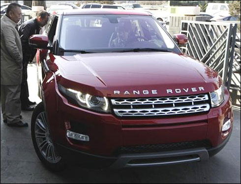 Customers look at a Range Rover Evoque.