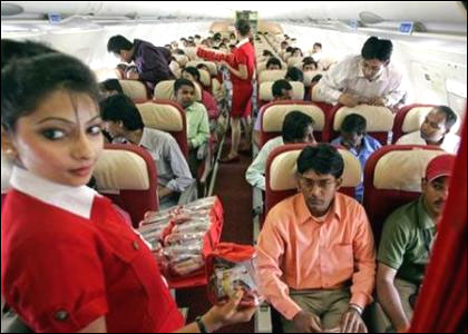 Stewardesses serve passengers inside a Kingfisher Airlines aircraft.