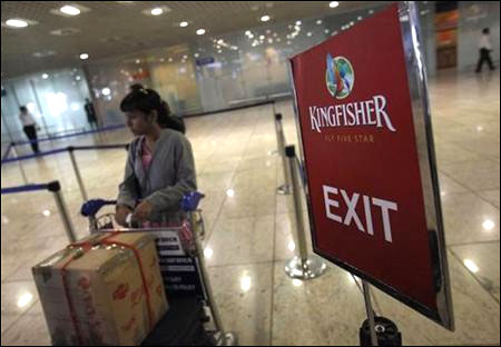 A lone Kingfisher Airlines customer waits in a check-in queue at Mumbai's domestic airport.
