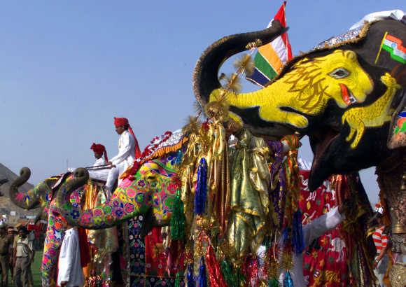 Mahouts sit on decorated elephants during a competition of the Elephant Festival in Jaipur.