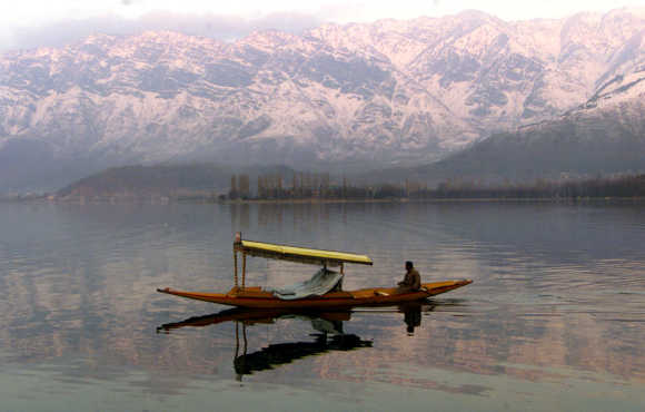 A Kashmiri man paddles his boat at Dal Lake in Srinagar.