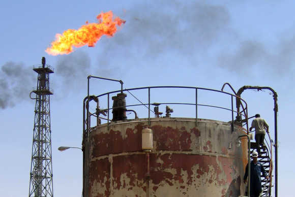Workers check equipment at the Al-Shuaeba oil refinery, about 15km southeast of the Iraqi city of Basra.