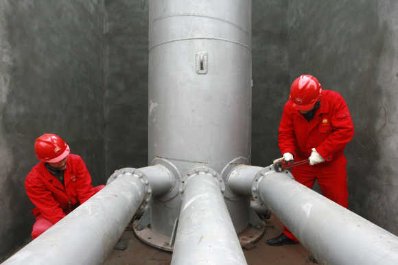Labourers work at a PetroChina refinery in Suining, southwest China's Sichuan province.
