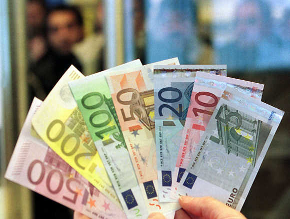 An official of the Volksbank Bosnia branch presents a handful of newly-launched euro banknotes in the capital Sarajevo.