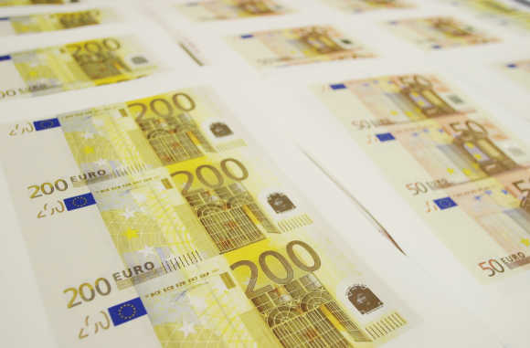 Counterfeit euro notes are shown at a Spanish police station in Madrid.