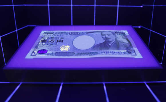 A 10,000 yen is displayed under a light at the currency museum of the Bank of Japan in Tokyo.