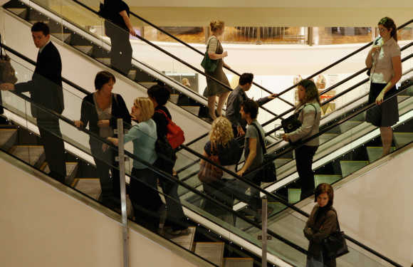 Customers use the escalators at a shopping centre in central Sydney.