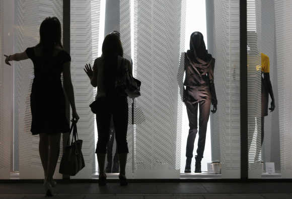 Women look at displays in a H&M store in Tokyo's Ginza shopping district.
