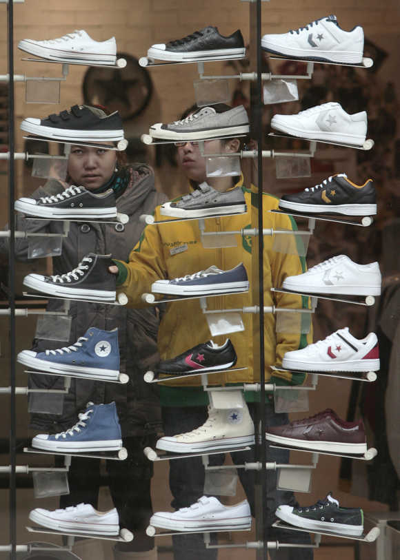 Consumers look at shoes on display at a shop in Nanjing, Jiangsu province, China.