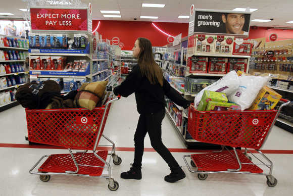A woman pulls shopping carts in Torrington, Connecticut.