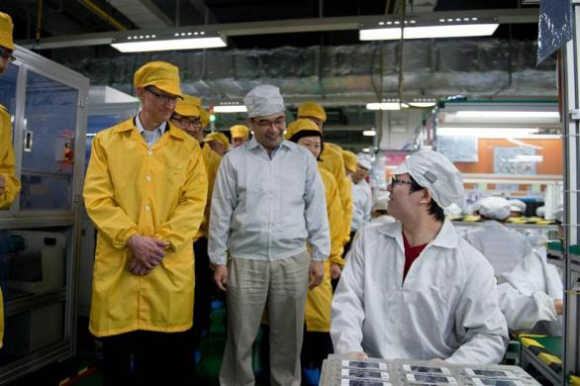 Apple CEO Tim Cook, left, visits the iPhone production line at the Foxconn Zhengzhou Technology Park in Zhengzhou, Henan province, China.