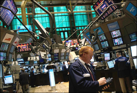 Financial professionals work on the floor of the New York Stock Exchange.