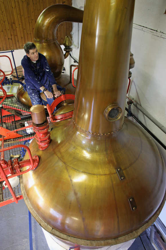 Jimmy Kennedy works on a copper still at Edradour distillery.