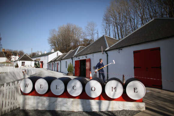 Jimmy Kennedy paints a wall at Edradour distillery.