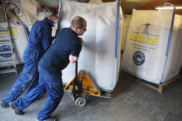 Jimmy Kennedy and Bose Mathias bring in a delivery of malt at Edradour distillery.