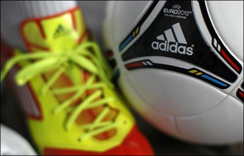 A shoe and a soccer ball by German sporting goods maker are pictured before the company