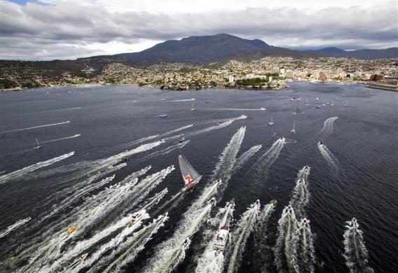 Australian supermaxi Wild Oats XI, centre, approaches the finish line at Hobart during the annual Sydney to Hobart yacht race.